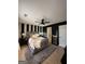 Charming bedroom featuring a striped accent wall, ceiling fan, plush rug, and modern decor at 7050 Galloway Pt, Riverdale, GA 30296