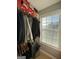 Closet features clothing racks, storage shelves, natural light from a window, and a laundry basket at 7050 Galloway Pt, Riverdale, GA 30296