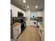 Bright kitchen with stainless steel appliances, butcher block countertops, and sleek white cabinets at 7050 Galloway Pt, Riverdale, GA 30296
