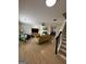 Bright living room with wood floors, a ceiling fan, a cozy fireplace, and comfortable seating at 7050 Galloway Pt, Riverdale, GA 30296