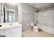Bathroom features a vanity with a sink, toilet, and tub with a shower at 1875 Cutleaf Creek Rd, Grayson, GA 30017