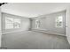 Spacious carpeted bedroom featuring neutral paint, multiple windows, and great natural light at 1875 Cutleaf Creek Rd, Grayson, GA 30017