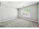 Bright bedroom with plush carpet, fresh gray paint, and plenty of natural light at 1875 Cutleaf Creek Rd, Grayson, GA 30017