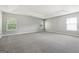 Large carpeted bedroom with neutral paint, many windows, and a trey ceiling at 1875 Cutleaf Creek Rd, Grayson, GA 30017