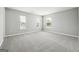 Empty bedroom with neutral colored walls, carpet, and multiple windows allowing for natural light at 1875 Cutleaf Creek Rd, Grayson, GA 30017