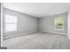 Empty bedroom with neutral colored walls, carpet, and multiple windows allowing for natural light at 1875 Cutleaf Creek Rd, Grayson, GA 30017