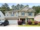 Charming two-story home with a stone-accented facade, attached garage, and well-maintained landscaping at 1875 Cutleaf Creek Rd, Grayson, GA 30017