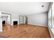 Spacious living room featuring hardwood floors, a fireplace, and neutral paint, with ample natural light at 1875 Cutleaf Creek Rd, Grayson, GA 30017