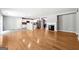 Open-concept living room with hardwood floors, a fireplace, and views of the adjacent kitchen and dining areas at 1875 Cutleaf Creek Rd, Grayson, GA 30017