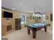 Basement recreational area with pool table, built-in shelving, and a window for natural light at 230 Cobblestone Ln, Mcdonough, GA 30252