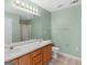 Bathroom featuring a double sink vanity with a framed mirror and a shower with gold trim at 230 Cobblestone Ln, Mcdonough, GA 30252