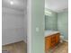 Bathroom featuring a double sink vanity with a framed mirror and a closet at 230 Cobblestone Ln, Mcdonough, GA 30252