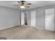 Spacious bedroom featuring neutral paint, a ceiling fan, and three closets for ample storage at 230 Cobblestone Ln, Mcdonough, GA 30252
