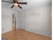 Bedroom featuring hardwood floors, ceiling fan, and a view to another room at 230 Cobblestone Ln, Mcdonough, GA 30252
