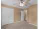 This bedroom has a carpet, ceiling fan, and double door closet for storage and comfort at 230 Cobblestone Ln, Mcdonough, GA 30252