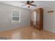 Bedroom with hardwood floors, ceiling fan, large window, and vintage wardrobe at 230 Cobblestone Ln, Mcdonough, GA 30252