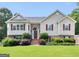 Inviting two-story home featuring a lush green lawn and a brick-accented entrance at 230 Cobblestone Ln, Mcdonough, GA 30252