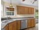 Kitchen featuring stainless steel dishwasher, double sink, and view to outdoor space at 230 Cobblestone Ln, Mcdonough, GA 30252