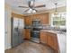 Well-equipped kitchen with stainless steel refrigerator, stove, microwave, and decorative backsplash at 230 Cobblestone Ln, Mcdonough, GA 30252