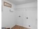 A simple laundry room with tiled floors and wire racks for storage at 230 Cobblestone Ln, Mcdonough, GA 30252