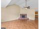 Open living room with hardwood floors, a brick fireplace, and vaulted ceilings at 230 Cobblestone Ln, Mcdonough, GA 30252