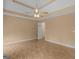 Large main bedroom featuring tray ceilings, a ceiling fan, and neutral walls at 230 Cobblestone Ln, Mcdonough, GA 30252
