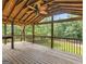 Covered porch with ceiling fan overlooking a treed backyard at 230 Cobblestone Ln, Mcdonough, GA 30252