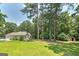 Lush backyard featuring a storage shed, mature trees, and the rear of the well-maintained home at 100 Riveredge Dr, Mcdonough, GA 30252