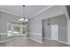 Elegant dining room area with bay window and decorative lighting fixture creates a warm ambiance at 100 Riveredge Dr, Mcdonough, GA 30252