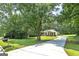 Charming home with well-manicured lawn, mature trees, and a long driveway leading to the house at 100 Riveredge Dr, Mcdonough, GA 30252