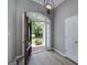 Welcoming foyer featuring wood floors, a decorative light fixture, and a glimpse of the outdoors at 100 Riveredge Dr, Mcdonough, GA 30252