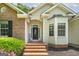 Inviting entrance with brick steps, decorative door, and bay window enhances curb appeal at 100 Riveredge Dr, Mcdonough, GA 30252