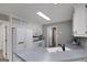 Bright kitchen features white cabinets, appliances, and a functional countertop island with a sink at 100 Riveredge Dr, Mcdonough, GA 30252