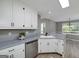 Functional kitchen with white cabinets, stainless steel appliances, and a view into the dining area at 100 Riveredge Dr, Mcdonough, GA 30252