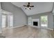 Bright living room with high ceilings, a cozy fireplace, and views of the backyard at 100 Riveredge Dr, Mcdonough, GA 30252