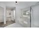 Elegant main bathroom featuring a separate tub, glass-enclosed shower, and access to a walk-in closet at 100 Riveredge Dr, Mcdonough, GA 30252