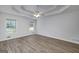 Bright main bedroom features wood-look floors, windows, and a ceiling fan for added comfort at 100 Riveredge Dr, Mcdonough, GA 30252