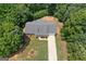 Aerial view of the home showcasing the mature trees on the property, along with a long driveway at 225 Chinns Way, Hampton, GA 30228