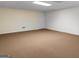 Spacious basement featuring neutral carpet, white brick wall and a white door at 225 Chinns Way, Hampton, GA 30228
