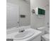 Bathroom with a single sink vanity, white fixtures, and a framed mirror at 225 Chinns Way, Hampton, GA 30228