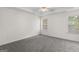 Spacious bedroom features plush gray carpeting and natural light from two windows at 225 Chinns Way, Hampton, GA 30228