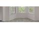 Bright breakfast nook with large windows and neutral tile flooring at 225 Chinns Way, Hampton, GA 30228