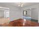 Dining room with hardwood floors and adjacent to both the kitchen and living room at 225 Chinns Way, Hampton, GA 30228