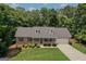 Inviting single-story home with well-manicured lawn and landscaping, nestled among mature trees at 225 Chinns Way, Hampton, GA 30228