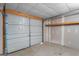 Attached garage with roll-up door and shelving at 225 Chinns Way, Hampton, GA 30228