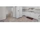 Bright eat-in kitchen with white cabinets and a view to the dining room and living room at 225 Chinns Way, Hampton, GA 30228