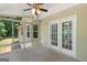 Cozy sunroom featuring a ceiling fan, carpet flooring and access to the exterior at 225 Chinns Way, Hampton, GA 30228