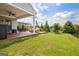 Covered back porch with ceiling fan, outdoor furniture, and a green backyard at 411 Southbridge Pass, Peachtree City, GA 30269