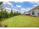 Large green backyard with a black metal fence, deck, and covered patio at 411 Southbridge Pass, Peachtree City, GA 30269