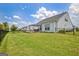 A spacious backyard features a black metal fence, lawn, deck and view of adjacent homes at 411 Southbridge Pass, Peachtree City, GA 30269
